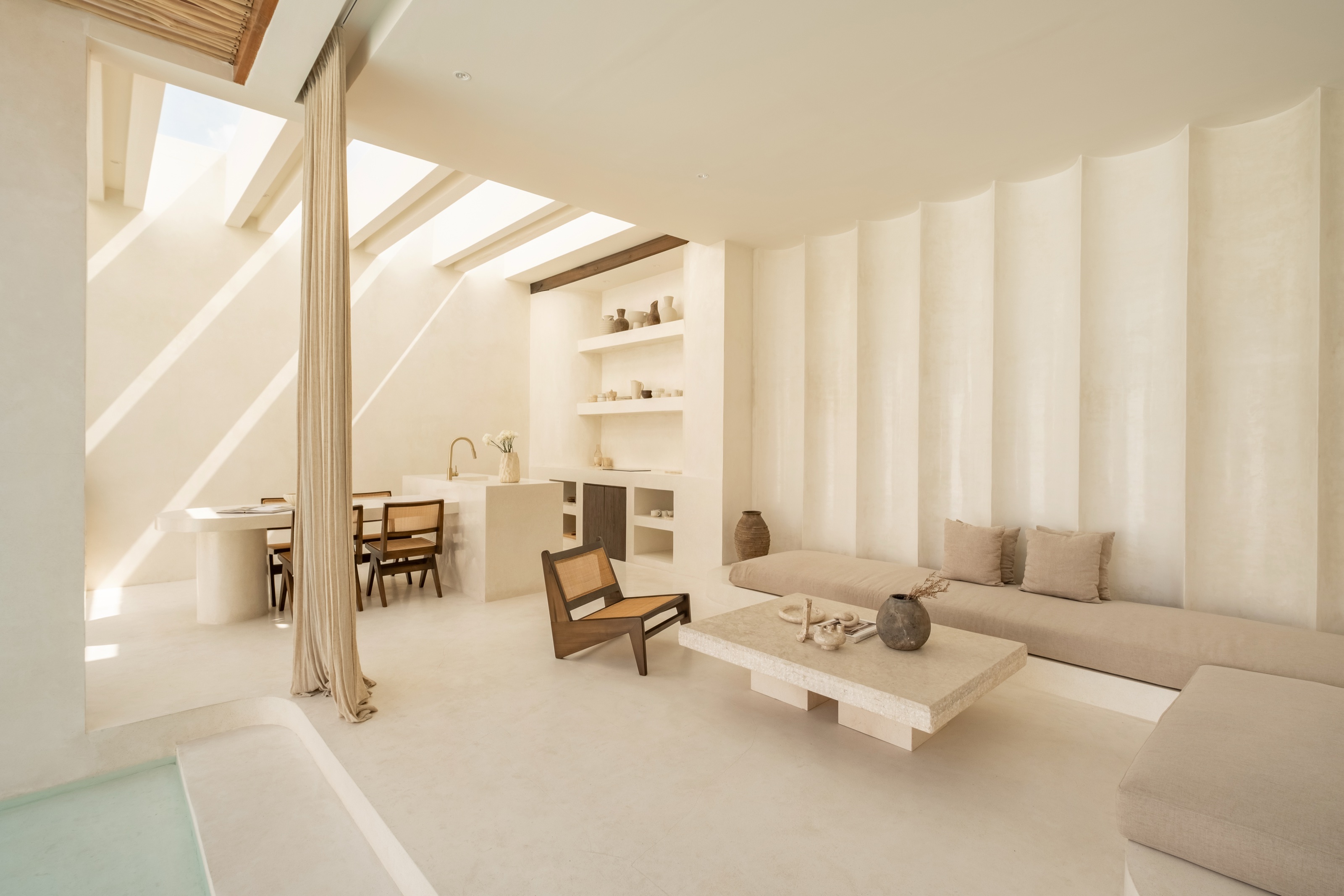 Living room opening onto the pool at Villa 02